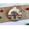 ornament with candy cane background, includes buttons, cranberry pips, a stamp, mini ticket strip, and a mini ornament tag.